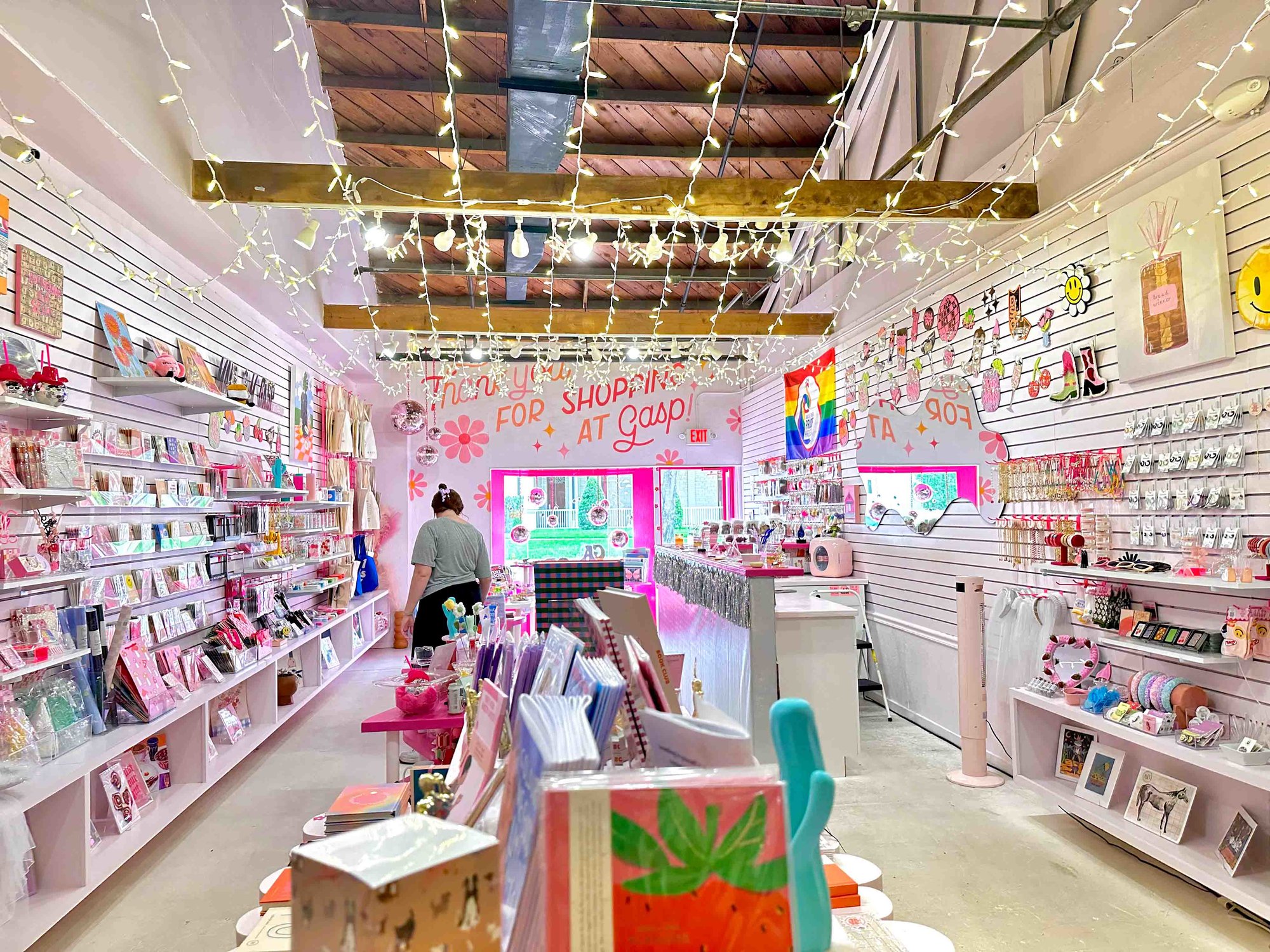 inside of building with white walls and shelves with various brightly colored items